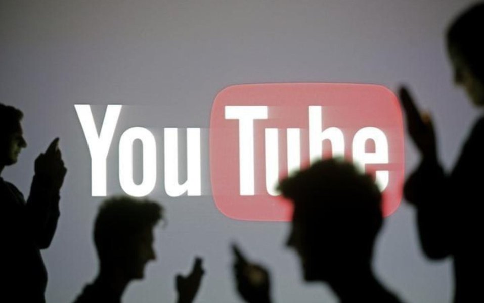 Silhueta de pessoas em frente ao logo do Youtube projetado 29/10/2014 REUTERS/Dado Ruvic