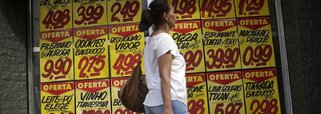 Consumidora passa por cartazes com preços de produtos em mercado no Rio de Janeiro 09/12/2017 REUTERS/Ricardo Moraes