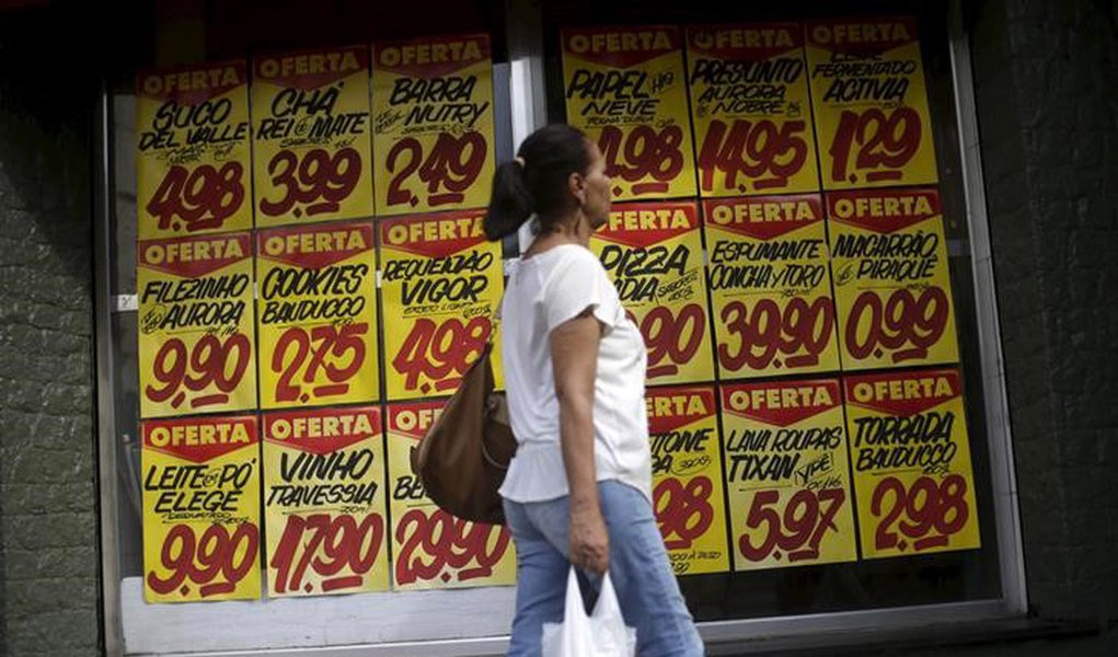 Consumidora passa por cartazes com preços de produtos em mercado no Rio de Janeiro 09/12/2017 REUTERS/Ricardo Moraes