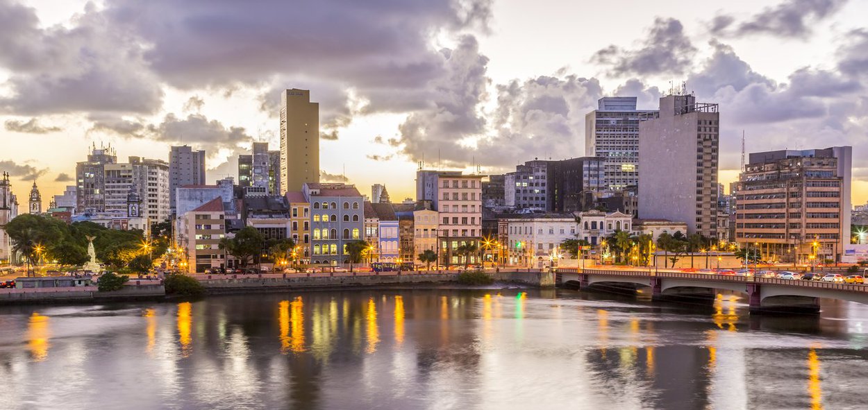 Skyline of Recife in Pernambuco, Brazil showcasing its historic architecture at sunset by the Capibaribe River.