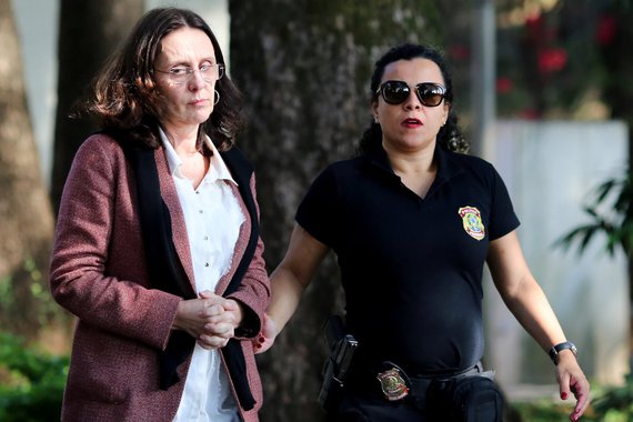 Andrea Neves, sister of Brazilian Senator Aecio Neves, is escorted by a federal police officer as she arrives to the Institute of Forensic Science in Belo Horizonte, Brazil, May 18, 2017. REUTERS/Cristiane Mattos