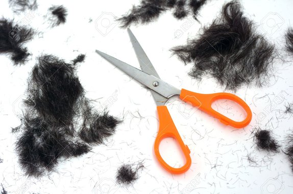 Trimmed hair on the floor with scissors.fashion concept