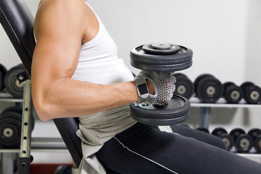 health club: guy in a gym doing weight lifting