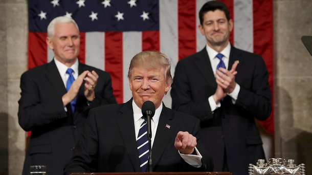 US Vice President Mike Pence (L) and Speaker of the House Paul Ryan (R) applaud as US President Donald J. Trump (C) arrives to deliver his first address to a joint session of Congress from the floor of the House of Representatives in 