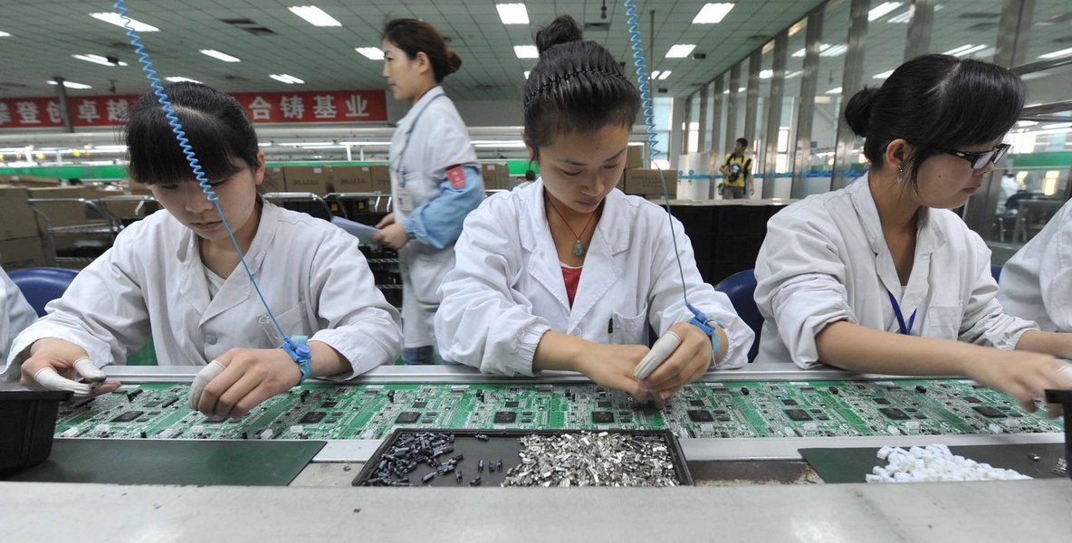 Chinese workers assembling circuit boards at a factory in Mianyang, southwest China's Sichuan province on April 30, 2012. China's manufacturing activity rose in April to a 13-month high, o