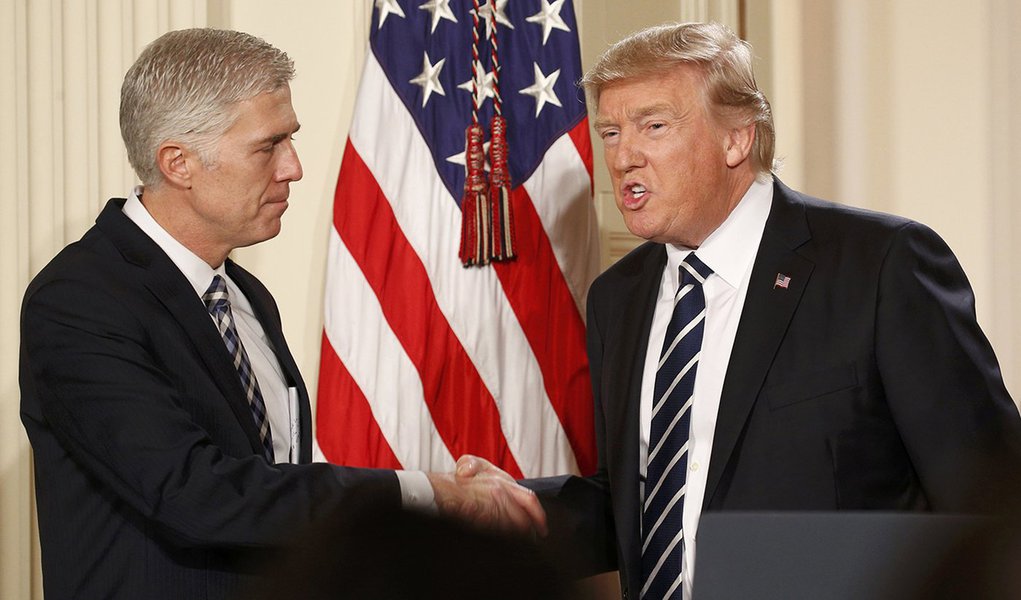 U.S. President Donald Trump shakes hands with Neil Gorsuch (L) after nominating him to be an associate justice of the U.S. Supreme Court at the White House in Washington, D.C., U.S., January 31, 2017. REUTERS/Kevin Lamarque
