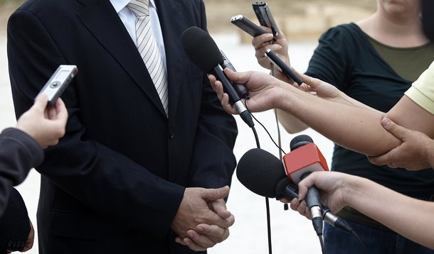 close up of conference meeting microphones and businessman