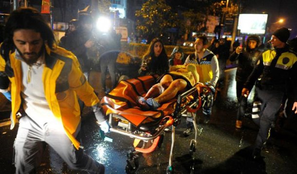 An injured woman is carried to an ambulance from a nightclub where a gun attack took place during a New Year party in Istanbul, Turkey, January 1, 2017. Murat Ergin/Ihlas News Agency via REUTERS