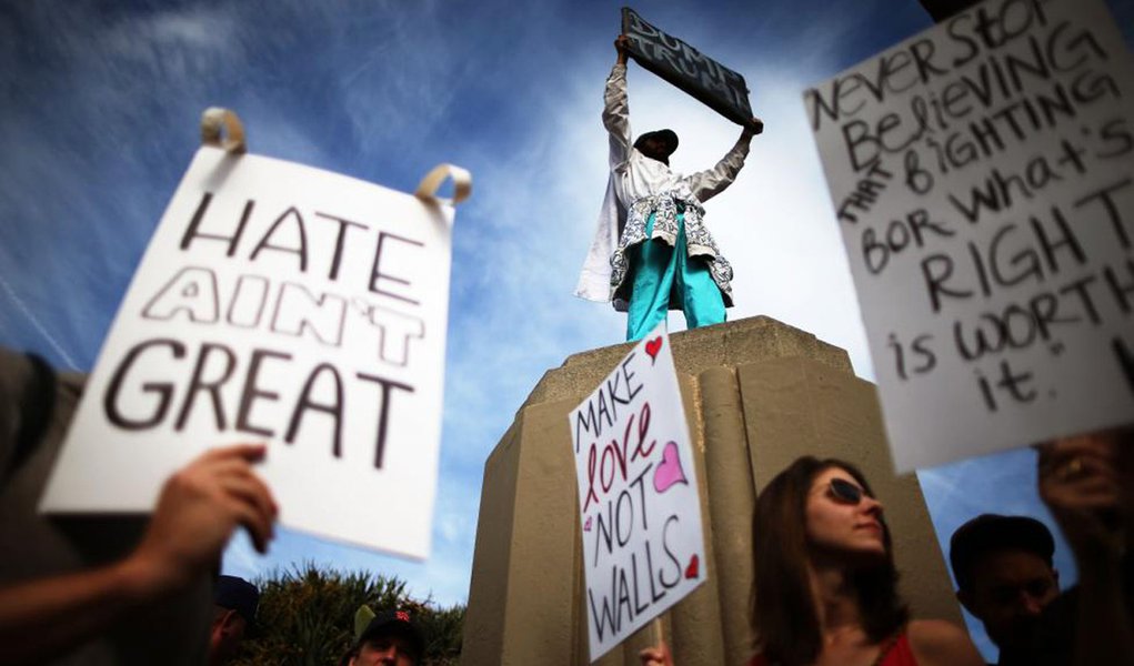 Reuters / Saturday, November 12, 2016 Protesters hold up signs during a march and rally against President-elect Donald Trump in Los Angeles, California.