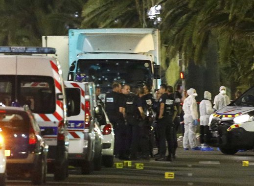 French police forces and forensic officers stand next to a truck July 15, 2016 that ran into a crowd celebrating the Bastille Day national holiday on the Promenade des Anglais killing at least 60 people in Nice, France, July 14. REUTERS/Eric Gaillard