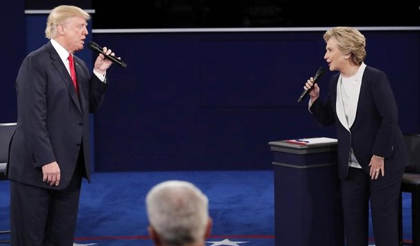 Republican U.S. presidential nominee Donald Trump and Democratic U.S. presidential nominee Hillary Clinton speak during their presidential town hall debate at Washington University in St. Louis, Missouri, U.S., October 9, 2016. REUTERS/Jim Young