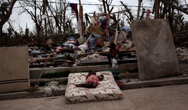Two girls play amid the rubble after Hurricane Matthew in a street of Port-a-Piment, Haiti, October 9, 2016. REUTERS/Andres Martinez Casares