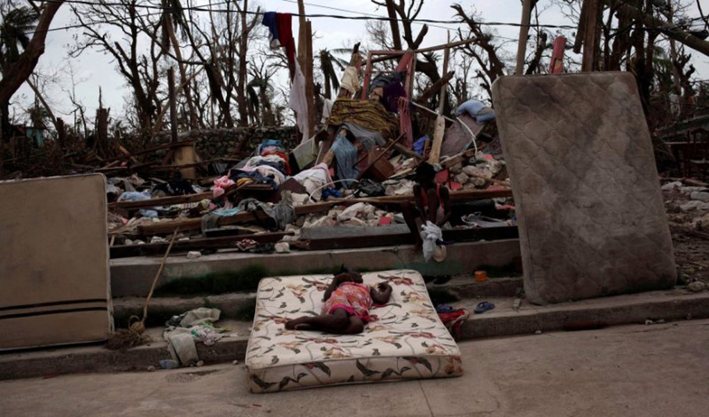 Two girls play amid the rubble after Hurricane Matthew in a street of Port-a-Piment, Haiti, October 9, 2016. REUTERS/Andres Martinez Casares