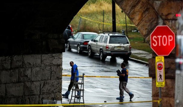 Federal Bureau of Investigation (FBI) officials walk near the area where an explosive device left at a train station was detonated by the authorities in Elizabeth, New Jersey, U.S., September 19, 2016. REUTERS/Eduardo Munoz