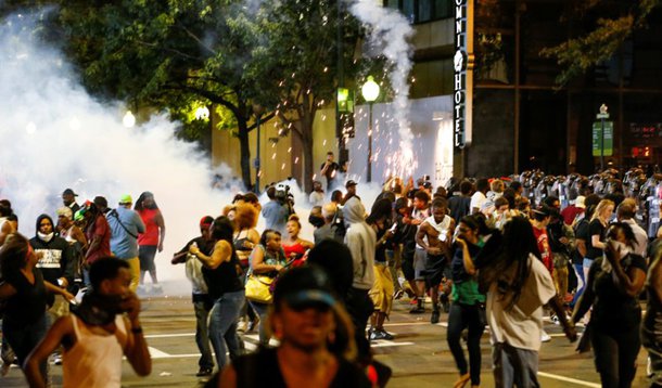 People run from flash-bang grenades in uptown Charlotte, NC during a protest of the police shooting of Keith Scott, in Charlotte, North Carolina, U.S. September 21, 2016. REUTERS/Jason Miczek