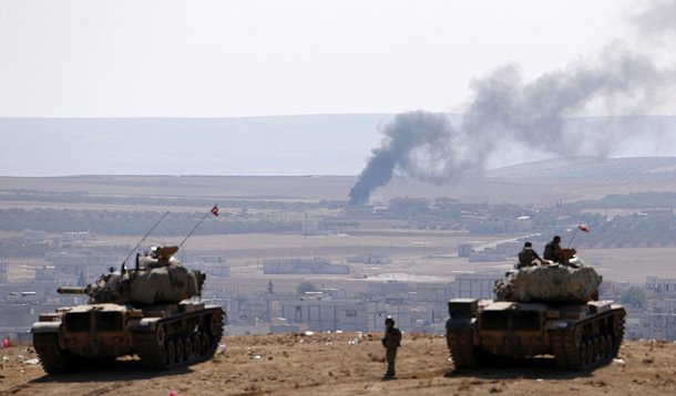 Smoke rises from the Syrian town of Kobani, Turkish army tanks take position on the Turkish 