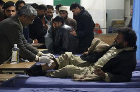 Homem recebendo auxílio médico após explosão em escritório do governo no Paquistão. 29/12/2015 REUTERS/Khuram Parvez