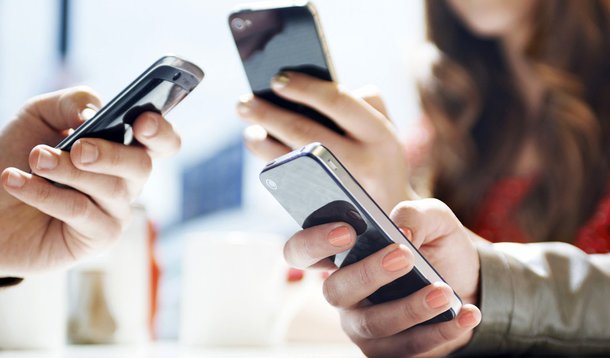 hands texting with mobile phones in cafe