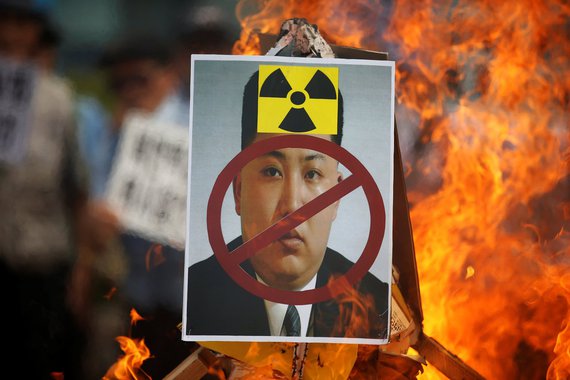 A cut-out of North Korean leader Kim Jong Un is set on fire during an anti-North Korea rally in central Seoul, South Korea, September 10, 2016. REUTERS/Kim Hong-Ji