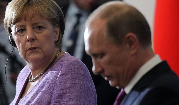 SAINT PETERSBURG, RUSSIA - JUNE 21:  Russian President Vladimir Putin (R) and German Chancellor Angela Merkel (L) attend a joint press conference during the Saint Petersburg International Economy Forum on June 21, 2013 in Saint Petersburg, Russia. Putin g