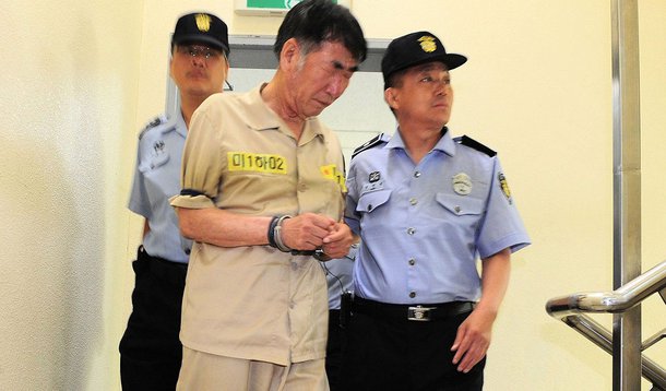 The captain of the sunken ferry Sewol, Lee Joon-Seok (left) arrives on the second day of his trial at the Gwangju District Court in Gwanju, southwestern South Korea, in June.
