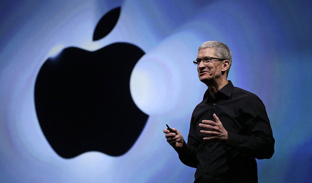 FILE - In this Wednesday, Sept. 12, 2012, file photo, Apple CEO Tim Cook speaks following an introduction of the new iPhone 5 in San Francisco. Apple is emerging as a gentler, cuddlier corporate citizen in the year after the death of CEO and co-founder St
