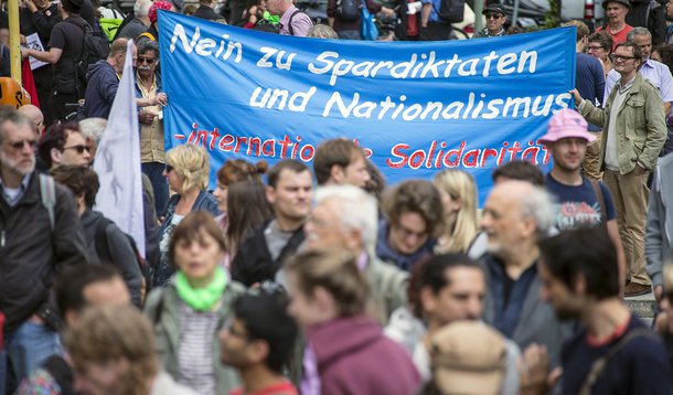 Activists attend a demonstration on World Refugee Day in Berlin, Germany, June 20, 2015. The banner reads, "No to austerity measures - international solidarity". REUTERS/Hannibal Hanschke 