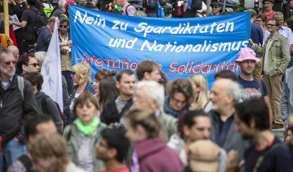 Activists attend a demonstration on World Refugee Day in Berlin, Germany, June 20, 2015. The banner reads, "No to austerity measures - international solidarity". REUTERS/Hannibal Hanschke 