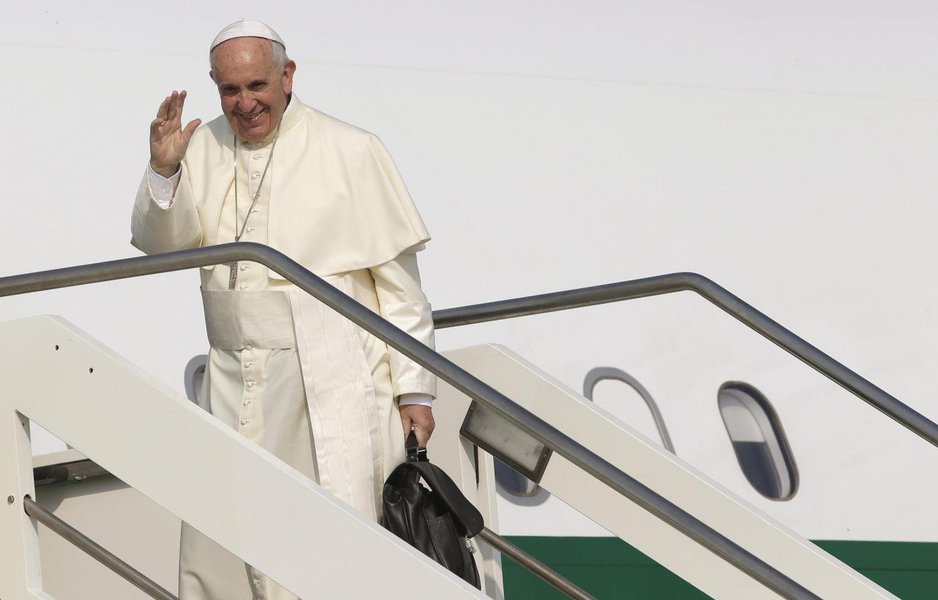 Pope Francis waves as he boards a plane for his pastoral trip, at Fiumicino airport in Rome, Italy, July 5, 2015.
