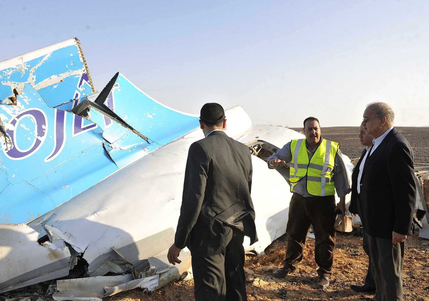 CORRECTS DAY OF WEEK TO SATURDAY, NOT FRIDAY - In this photo released by the Prime Minister's office, Sherif Ismail, right, looks at the remains of a crashed passenger jet in Hassana, Egypt on Saturday, Oct. 31, 2015. 