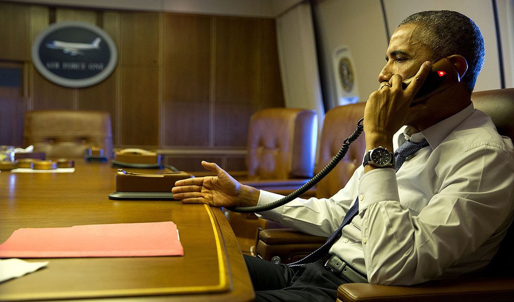 President Barack Obama talks on the phone with French President Francois Hollande from aboard Air Force One, Jan. 7, 2015.
(Official White House Photo by Pete Souza)