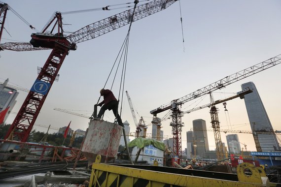 Operário trabalha em um canteiro de obras no bairro financeiro da região central de Pequim. A China cresceu no terceiro trimestre no ritmo mais fraco desde a crise financeira global. A retomada na produção industrial e a confiança do governo de que o merc
