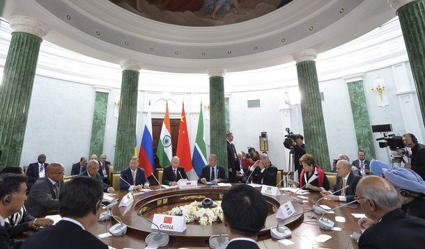 Participants sit at a table during a BRICS leaders' meeting at the G20 Summit in Strelna near St. Petersburg, September 5, 2013. REUTERS/Alexander Vilf/RIA Novosti/Pool (RUSSIA - Tags: POLITICS BUSINESS) ATTENTION EDITORS - THIS IMAGE HAS BEEN SUPPLIED BY