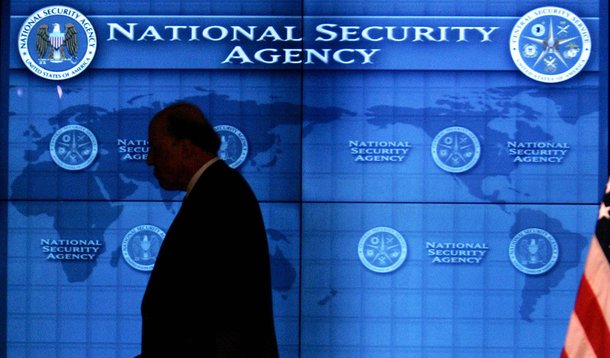 U.S. National Intelligence Director John Negroponte walks past a video screen during a visit by U.S. President George W. Bush at the National Security Agency (NSA) at Fort Meade, Maryland, January 25, 2006. President Bush visited the ultra-secret National