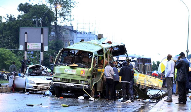 Damaged vehicles are seen at the scene of a blast near Pangani Police Station in Kenya's capital Nairobi, December 14, 2013. A suspected grenade attack on a minibus in Kenya's capital on Saturday killed at least four people near a Somali-dominated area of