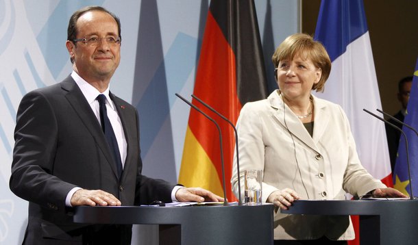 German Chancellor Angela Merkel and French President Francois Hollande address a news conference after their talks in the Chancellery in Berlin, May 15, 2012. Hollande was greeted by a thunderstorm in Paris and storm clouds gathering over the euro zone as