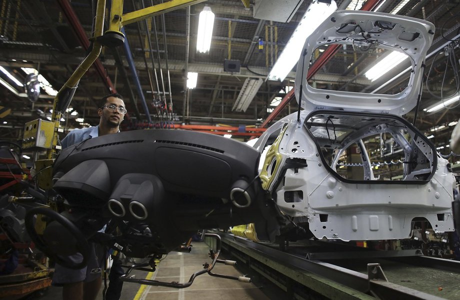 A Brazilian worker assembles a Ford car on an assembly line  at Sao Bernardo do Campo Ford plant, near Sao Paulo August 13, 2013. The pace of vehicle production in Brazil slipped in July to the lowest daily rate in five months as factories, facing sagging