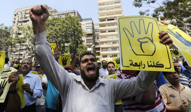 Members of the Muslim Brotherhood and supporters of ousted Egyptian President Mohamed Mursi shout slogans against the military and the interior ministry as they make the "Rabaa" or "Four" gesture, during a protest march towards Mohandessin in Cairo August