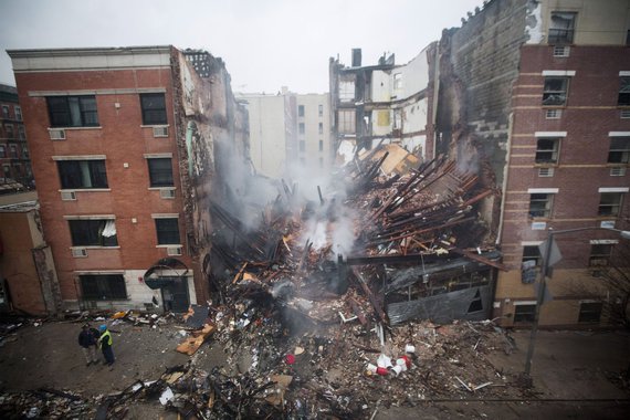 New York City firefighters work at the site of a building explosion and collapse in the Harlem section of New York, March 12, 2014. Two New York City buildings collapsed on Wednesday in an explosion believed to be caused by a gas leak, killing two people,
