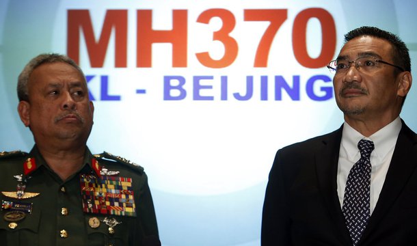 Malaysia's acting Transport Minister Hishammuddin Hussein listens to questions next to Chief of Armed Forces General Zulkifeli Mohd. Zin (L) during a news conference about the missing Malaysia Airlines MH370 plane at Kuala Lumpur International Airport Mar