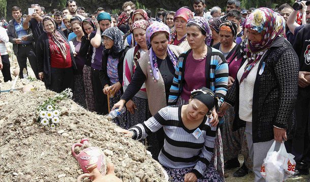 Mulheres acompanham o enterro de um mineiro morto no incÃªndio em uma mina de carvÃ£o, em um cemitÃ©rio em Soma, na Turquia, nesta quinta-feira. 15/05/2014 REUTERS/Osman Orsal
