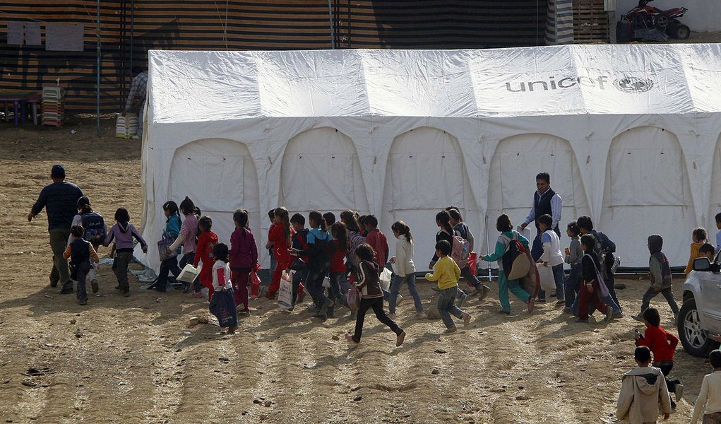 Syrian refugee children walk together to receive their polio vaccine during a vaccination campaign at a Syrian refugee camp near Zahle town in the Bekaa Valley November 8, 2013. Lebanon launched a massive public health initiative on Friday to vaccinate al