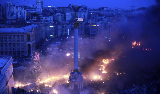 Smoke rises above Independence Square during anti-government protests in central Kiev in the early hours of February 19, 2014. Ukrainian President Viktor Yanukovich accused pro-European opposition leaders on Wednesday of trying to seize power by force aft