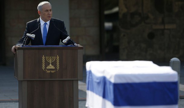 Israel's Prime Minister Benjamin Netanyahu speaks near the flag draped coffin of former Israeli Prime Minister Ariel Sharon during a memorial ceremony for Sharon at the Knesset, Israel's parliament, in Jerusalem January 13, 2014. Israel paid homage to Sha