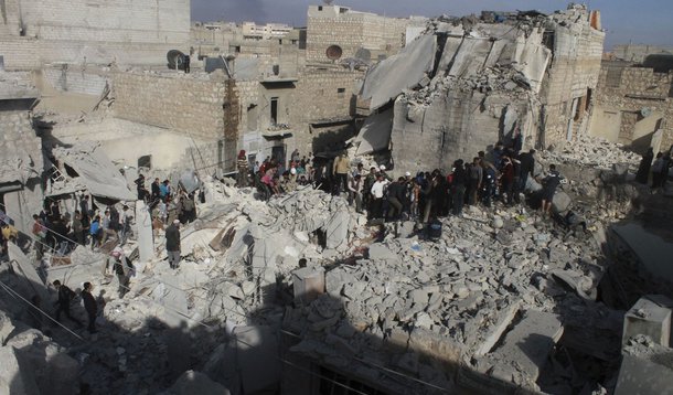 People search for survivors amid the rubble of collapsed buildings after what activists said was shelling by forces loyal to Syria's President Bashar al-Assad in the Karam el-Beik district of Aleppo November 23, 2013. Air strikes around the northern Syria