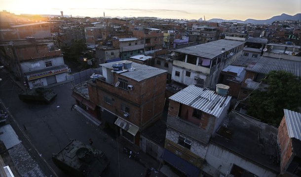 Armored vehicles from the Brazilian Navy patrol during an operation at the Mare slums complex in Rio de Janeiro March 30, 2014. The Federal troops and police occupied the Mare slums complex on Sunday to help quell a surge in violent crime following attack
