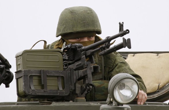 A Russian serviceman guards the Belbek airport in the Crimea region March 4, 2014. A column of unarmed Ukrainian servicemen arrived at the base for negotiations with Russian troops on Tuesday, local media reported. REUTERS/Vasily Fedosenko (UKRAINE - Tags