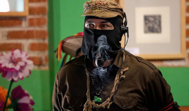 The leader of the Mexican Zapatista Army of National Liberation (EZLN), Subcomandante Marcos, smokes his pipe, during the opening of the forum "Digna Rabia" (Honorably Wrath) at the San Cristobal de las Casas Community, state of Chiapas, Mexio, on January