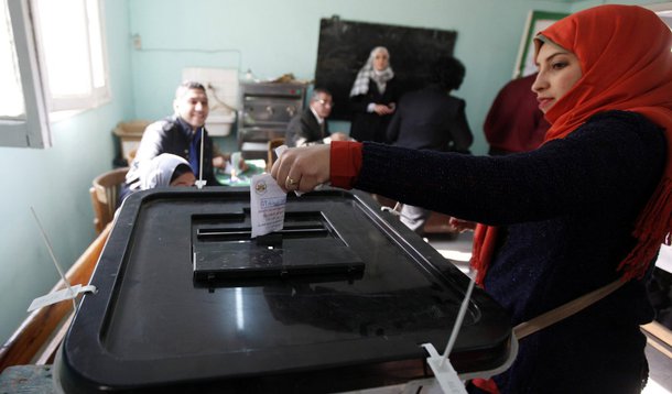 Women cast their votes at a polling centre during a referendum on Egypt's new constitution in Cairo January 14, 2014. Egyptians began voting on Tuesday in a constitutional referendum, the first ballot since the military overthrew Islamist president Mohame