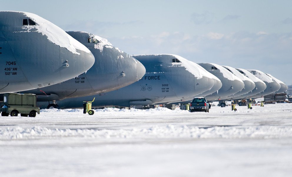 Snow-covered C-5M Super Galaxies sit on the flight line Jan. 3, 2014, at Dover Air Force Base, Del. This was the first snow storm of 2014 to hit the base. (U.S. Air Force photo/Roland Balik)